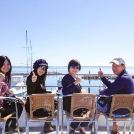 a group of people sitting at a beach