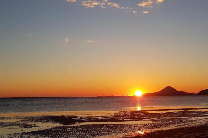 a sunset over a body of water