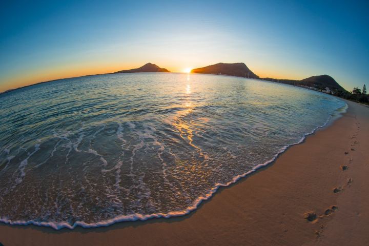 a view of a beach next to a body of water