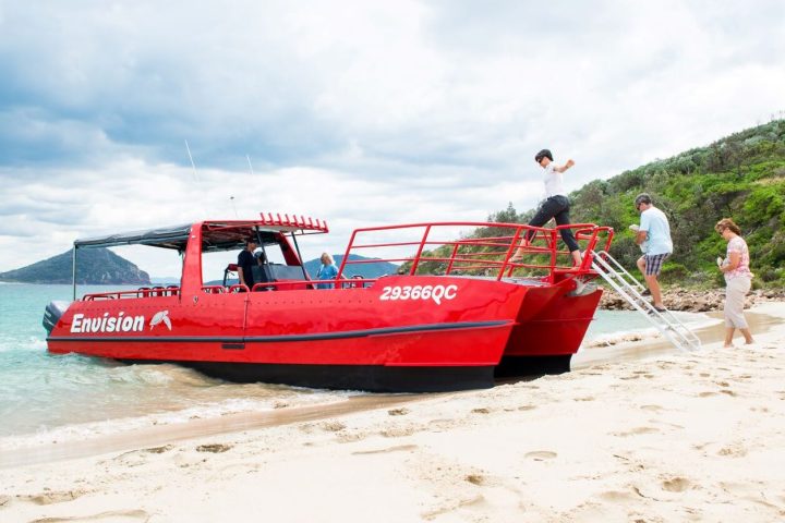 a boat sitting on top of a sandy beach