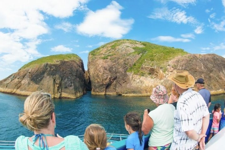 a group of people standing in front of a mountain