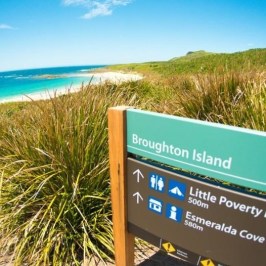 a sign above a body of water