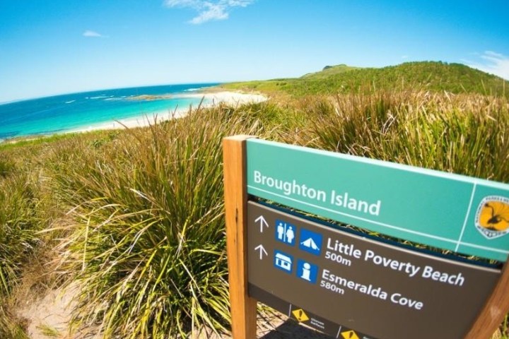 a sign above a body of water