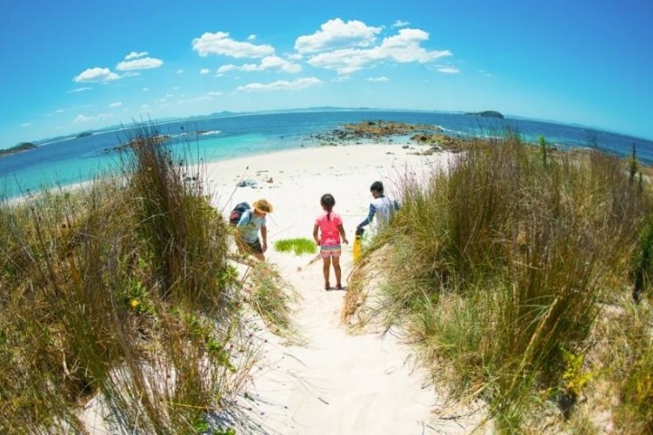 a person standing next to a body of water