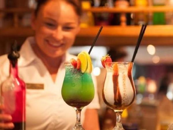 a person sitting at a table with a glass of wine