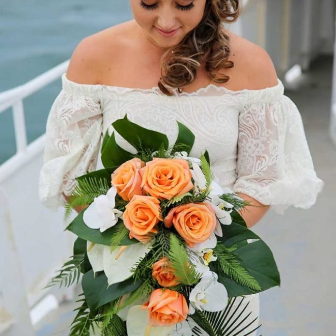 a person sitting at a table in front of a flower