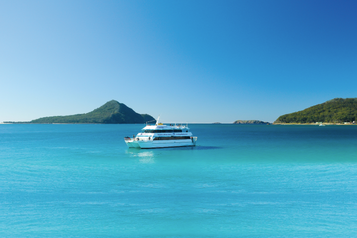 a blue boat sitting next to a body of water