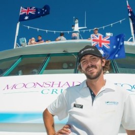 a man standing on a boat posing for the camera