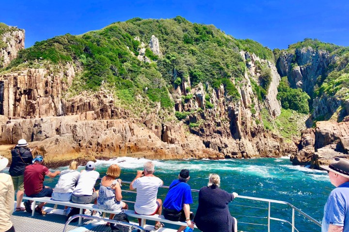 a group of people sitting on a rock