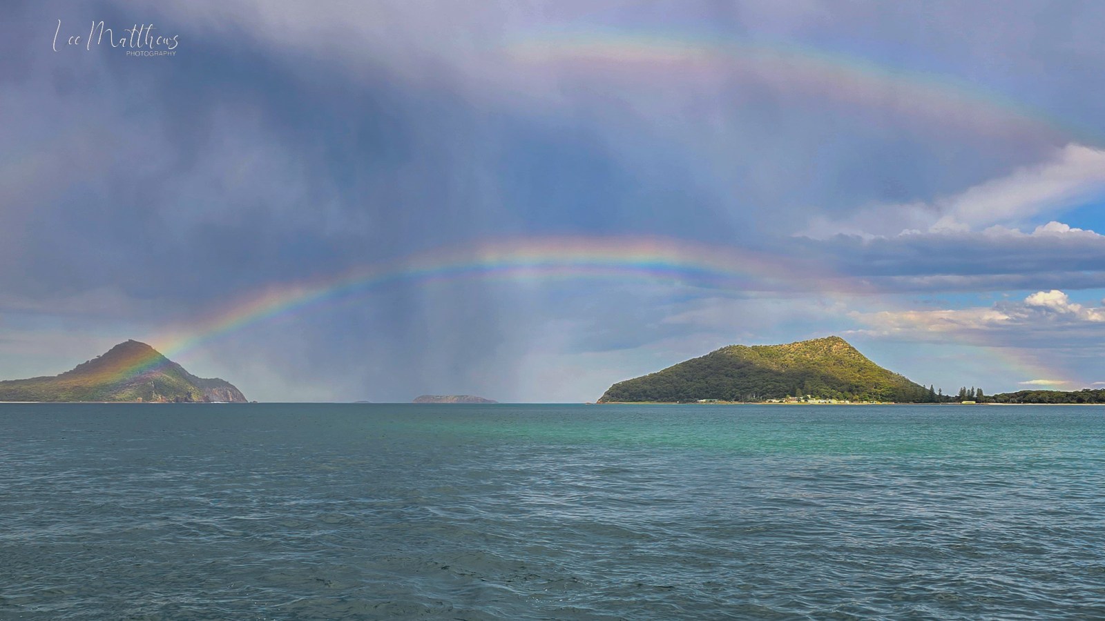 a rainbow over a body of water
