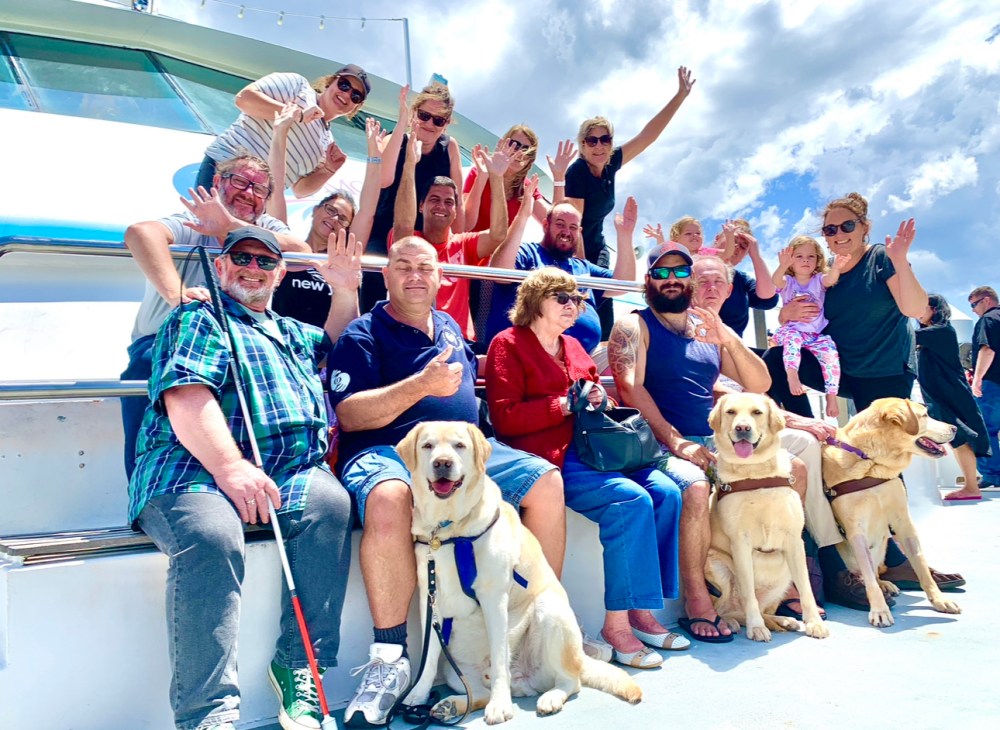 a group of people posing for a picture with a dog