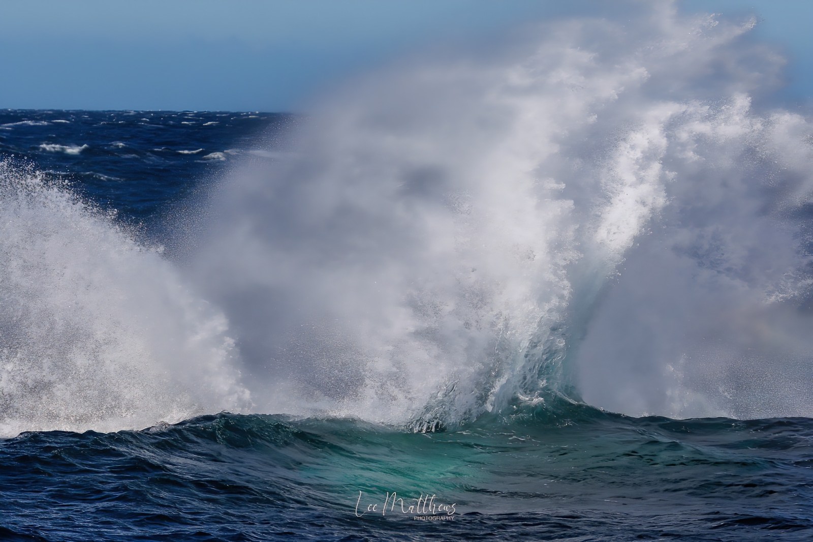 a man riding a wave on top of a body of water