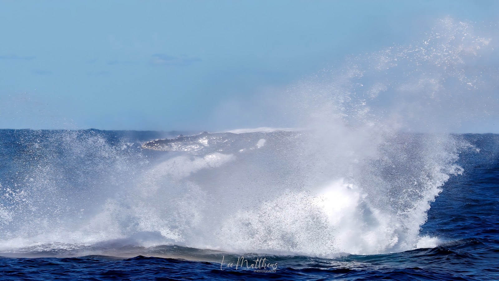 a man riding a wave on top of a body of water