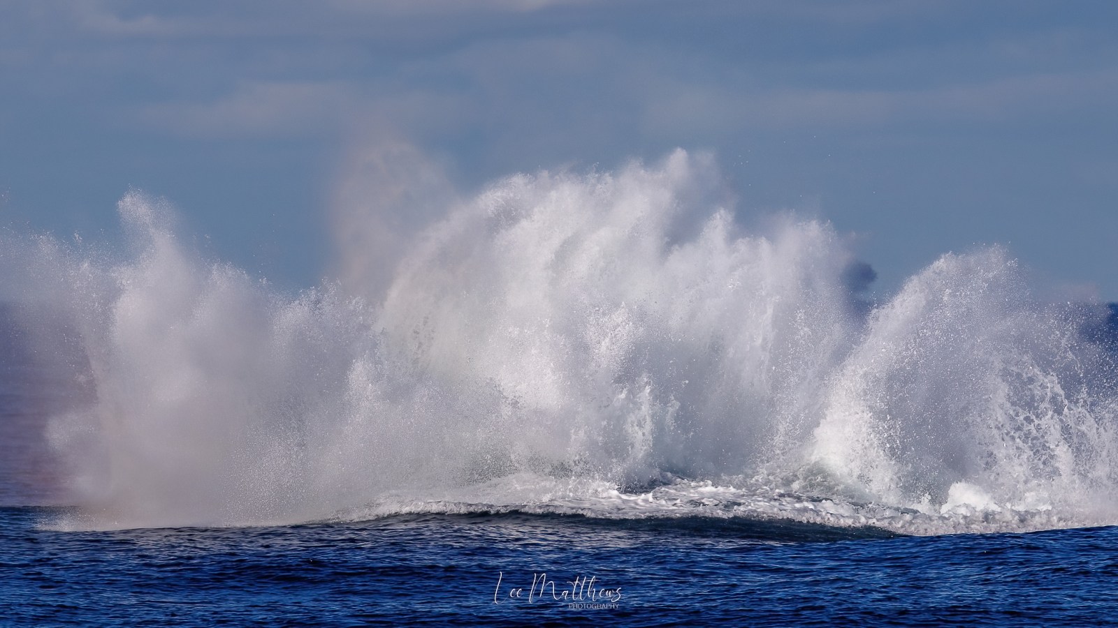 a man riding a wave on a surfboard in the water